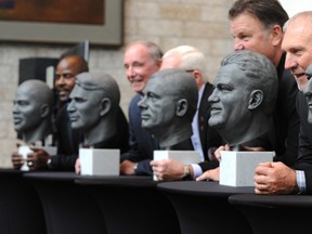 EDMONTON, ALTA: October Former Edmonton Eskimos receiver Brian Fryer (R) poses with a bust of himself at the Canadian Football Hall of Fame inductees bust unveiling also for other CFLer's Dan Ferrone, Miles Gorrell, Jake Ireland, Ted Loney (brother of Don Loney) and Earl Winfield, at the Winspear Centre in Edmonton, October 3, 2013.