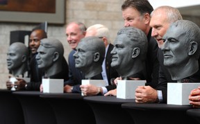 EDMONTON, ALTA: October Former Edmonton Eskimos receiver Brian Fryer (R) poses with a bust of himself at the Canadian Football Hall of Fame inductees bust unveiling also for other CFLer's Dan Ferrone, Miles Gorrell, Jake Ireland, Ted Loney (brother of Don Loney) and Earl Winfield, at the Winspear Centre in Edmonton, October 3, 2013.