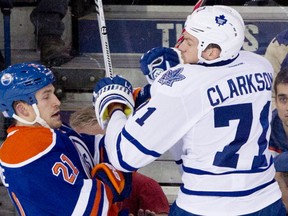 Toronto Maple Leafs winger David Clarkson (71) checks Edmonton Oilers defenceman Andrew Ference (21) during second period NHL hockey action in Edmonton on Tuesday, October 29, 2013.