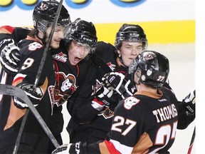 The Calgary Hitmen celebrate Brady Brassart’s goal during the second period of Calgary’s 4-3 overtime victory at the Saddledome on Friday, Oct. 4, 2013.