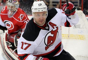 In this March 9, 2013, file photo, New Jersey Devils' Illya Kovalchuk (17), of Russia, skates away after scoring against Carolina Hurricanes' Dan Ellis, center, and Jay Harrison, left, during an NHL hockey game in Raleigh, N.C. Kovalchuk is retiring from the NHL and returning to Russia. The Devils announced the stunning news Thursday afternoon, July 11, 2013, in a statement, saying that the 30-year-old Kovalchuk had alerted general manager and president Lou Lamoriello earlier this year that he wanted to return home with his family after 11 seasons in the NHL.