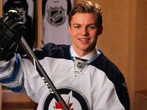 Josh Morrissey poses for a photo at the 2013 NHL Entry Draft in Newark, N.J., on June 30. The Winnipeg Jets took Morrissey with the 13th overall pick. The team signed defenceman Morrissey, the 18-year-old captain of the WHL's Prince Albert Raiders, to an entry-level contract on Oct. 3, 2013