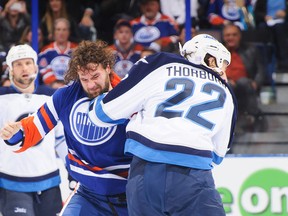 Luke Gazdic #20 of the Edmonton Oilers fights Chris Thorburn #22 of the Winnipeg Jets during an NHL game at Rexall Place on October 1, 2013 in Edmonton, Alberta, Canada.
(Source: Derek Leung/Getty Images North America)