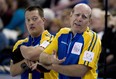 Alberta skip Kevin Martin talks over a shot as Ben Hebert looks on during a game in the Tim Hortons Brier Canadian men's curling championship at Rexall Place on March 8, 2013.