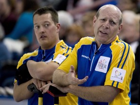 Alberta skip Kevin Martin talks over a shot as Ben Hebert looks on during a game in the Tim Hortons Brier Canadian men's curling championship at Rexall Place on March 8, 2013.