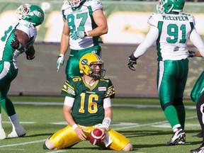 Edmonton Eskimos quarterback Matt Nichols shows his frustration after being sacked as Saskatchewan Roughriders’ Tearrius George (93) Aaron Hargreaves (87) and Jermaine McElveen (91) celebrate on Friday at Commonwealth Stadium.
Photograph by: JASON FRANSON , THE CANADIAN PRESS