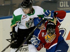 EDMONTON, ALBERTA: OCTOBER 15, 2013 - Edmonton Oil Kings Curtis Lazar (right) is checked by Prince Albert Raiders Carson Perreaux (left) during WHL game action in Edmonton on October 15, 2013. (PHOTO BY LARRY WONG/EDMONTON JOURNAL)