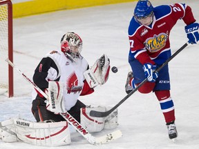 Moose Jaw Warriors goalie Justin Paulic, left, reaches for a shot deflected by Edmonton Oil Kings forward Curtis Lazar, right, during WHL action on Nov. 23, 2012, at Rexall Place. The Warriors host the Oil Kings Tuesday, Oct. 23, 2013, for the first game between the two Eastern Conference teams this season.