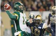 Edmonton Eskimos’ quarterback Mike Reilly, left, gets a pass away under pressure from Winnipeg Blue Bombers’ Henoc Muamba during first half CFL action in Winnipeg on Friday, Sept. 20, 2013.
Photograph by: John Woods, THE CANADIAN PRESS