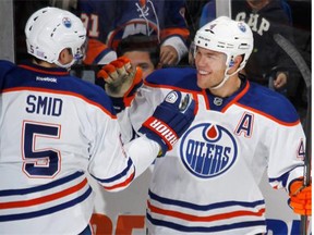 Taylor Hall, right, of the Edmonton Oilers celebrates his second goal of the first period at the 16 minute mark against the New York Islanders and is joined by Ladislav Smid during an NHL game in Uniondale, N.Y., on Thursday, Oct. 17, 2013. The Islanders won 3-2.