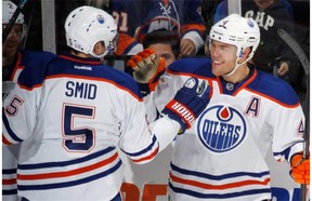 Taylor Hall, right, of the Edmonton Oilers celebrates his second goal of the first period at the 16 minute mark against the New York Islanders and is joined by Ladislav Smid during an NHL game in Uniondale, N.Y., on Thursday, Oct. 17, 2013. The Islanders won 3-2.