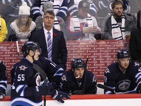 Claude Noel, head coach of the Winnipeg Jets, looks up to the replay in third period action in an NHL game against the Chicago Blackhawks at the MTS Centre on November 2, 2013 in Winnipeg.