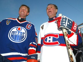Wayne Gretzky stands with Guy Lafleur during the Heritage Classic hockey game between the Edmonton Oilers and the Montreal Canadiens at Commonwealth Stadium on Nov. 22, 2003.
