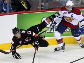 Calgary Hitmen left winger Jake Virtanen, left, flies through the air after colliding with Edmonton Oil Kings defenceman Griffin Reinhart during first period WHL action at the Scotiabank Saddledome on Nov. 3, 2013.