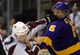 Kings defenseman Keaton Ellerby, right, fights Colorado Avalanche right wing Chuck Kobasew in NHL action last season.