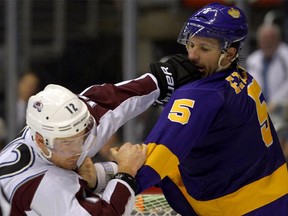 Kings defenseman Keaton Ellerby, right, fights Colorado Avalanche right wing Chuck Kobasew in NHL action last season.