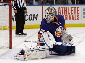New York Islanders goalie Kevin Poulin watches as Los Angeles Kings' Tyler Toffoli's third-period goal sails during the Kings' 3-2 victory in an NHL hockey game at Nassau Coliseum in Uniondale, N.Y., Thursday, Nov. 14, 2013.
