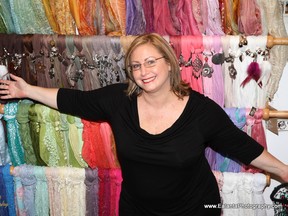 Mariana Konsolos of Princess Florence, beside her wall of scarves.