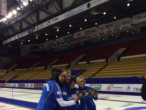 Renee Sonnenberg's rink of Lawnie MacDonald, Cary-Anne McTaggart and Rona Pasika pose for a picture after winning the Capital One Road to the Roar Olympic curling pre-trials on Saturday at the Kitchener Memorial Auditorium