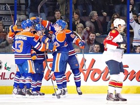 Florida Panthers Mike Mottau (22) skates past as Edmonton Oilers Ryan Nugent-Hopkins (93), Taylor Hall (4), Jordan Eberle (14), David Perron (57) and Nail Yakupov (64) celebrate a goal during first period NHL hockey action in Edmonton, Alta., on Thursday November 21, 2013. THE CANADIAN PRESS/Jason Franson