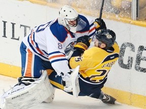 Edmonton Oilers' stopper Ilya Bryzgalov takes his assignment literally against Patric Hornqvist. (Photograph by: Mark Humphrey , AP)