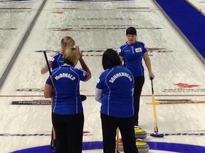 Grande Prairie's Renee Sonnenberg discusses a shot with teammates Lawnie MacDonald, Mary-Anne McTaggart and Rona Pasika during the Capital One Road to the Roar OIympic curling pre-trials at Kitchener, Ont., this week.