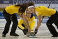 Rachelle Pidherny, left, and Joanne Courtney sweep skip Val Sweeting&#039;s rock during Saturday morning&#039;s women&#039;s playoff game in the Capital One Road to the Roar Olympic curling pre-trials  at the Kitchener Memorial Auditorium at Kitchener, Ont.