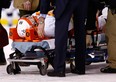 Brooks Orpik #44 of the Pittsburgh Penguins is carted off of the ice on a stretcher by the medical staff in the first period after an altercation with Shawn Thornton #22 of the Boston Bruins during the game at TD Garden on Dec. 7, 2013 in Boston.