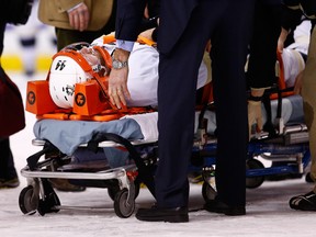 Brooks Orpik #44 of the Pittsburgh Penguins is carted off of the ice on a stretcher by the medical staff in the first period after an altercation with Shawn Thornton #22 of the Boston Bruins during the game at TD Garden on Dec. 7, 2013 in Boston.