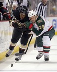 Anaheim Ducks right winger Devante Smith-Pelly, left, and Minnesota Wild centre Zenon Konopka race for the puck during an National Hockey League game in Anaheim, Calif., on Feb. 1, 2013.