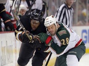 Anaheim Ducks right winger Devante Smith-Pelly, left, and Minnesota Wild centre Zenon Konopka race for the puck during an National Hockey League game in Anaheim, Calif., on Feb. 1, 2013.