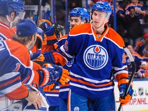 Edmonton Oilers defenceman Martin Marincin celebrates with the bench after the Oilers scored against the Colorado Avalanche during an NHL game at Rexall Place on December 5, 2013. The Oilers defeated the Avalanche 8-2.