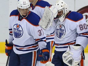 Ilya Bryzgalov of the Edmonton Oilers is helped off the ice after an injury during play against the Dallas Stars in the second period at American Airlines Center on Dec. 1, 2013 in Dallas.