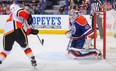 Jiri Hudler #24 of the Calgary Flames scores the game-winning goal on Devan Dubnyk #40 of the Edmonton Oilers during an NHL game at Rexall Place on Dec. 7, 2013 in Edmonton. The Flames beat the Oilers 2-1 in overtime.