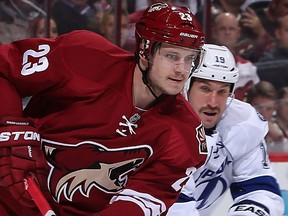 Oliver Ekman-Larsson #23 of the Phoenix Coyotes clears the puck from Valtteri Filppula #51 of the Tampa Bay Lightning during the NHL game at Jobing.com Arena on November 16, 2013 in Glendale, Arizona. The Coyotes defeated the Lightning 6-3.