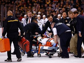 BOSTON, MA - DECEMBER 07: Brooks Orpik #44 of the Pittsburgh Penguins is carted off of the ice on a stretcher by the medical staff in the first period after an altercation with Shawn Thornton #22 of the Boston Bruins during the game at TD Garden on December 7, 2013 in Boston, Massachusetts.  (Photo by Jared Wickerham/Getty Images)