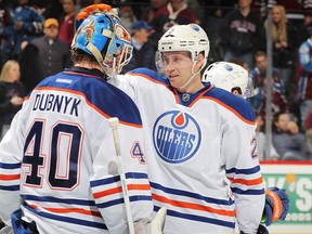 Devan Dubnyk and Jeff Petry in happier times, celebrating a shutout victory by the Oilers in Denver on March 12, 2013.
