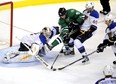 Dallas Stars centre Tyler Seguin fights for the puck with St. Louis Blues goalie Brian Elliott, center Maxim Lapierre (40) and defenceman Alex Pietrangelo iduring  an National Hockey League game at Dallas on Dec. 29, 2013.