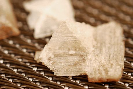 An extreme close-up of a large crystal of smoked Maldon salt.