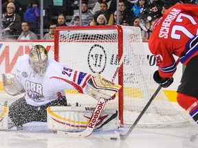 Mason McDonald #29 of Team Orr receives a snow shower as he eyes the shot of Nikita Scherbak #27 of Team Cherry during the CHL Top Prospects game at Scotiabank Saddledome on January 15, 2014 in Calgary, Alberta, Canada.