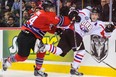 Nikolaj Ehlers #24 of Team Orr gets shoved into the boards by Aaron Irving #24 of Team Cherry during the CHL Top Prospects game at Scotiabank Saddledome on January 15, 2014 in Calgary, Alberta, Canada. Team Orr defeated Team Cherry 4-3.