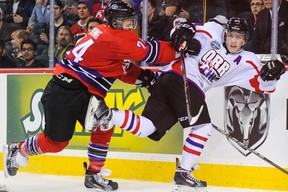 Nikolaj Ehlers #24 of Team Orr gets shoved into the boards by Aaron Irving #24 of Team Cherry during the CHL Top Prospects game at Scotiabank Saddledome on January 15, 2014 in Calgary, Alberta, Canada. Team Orr defeated Team Cherry 4-3.