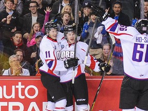 (L to R) Brendan Perlini #11, Jared McCann #19 and Josh Ho-Sang #66 of Team Orr celebrate the game-winning goal of Jared McCann #19 against Team Cherry during the CHL Top Prospects game at Scotiabank Saddledome on January 15, 2014 in Calgary, Alberta, Canada. Team Orr defeated Team Cherry 4-3.
