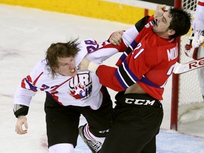 Team Orr defenceman Aaron Haydon, left, from the Nigara IceDogs and Team Cherry defenceman Jacob Middleton, right, from the Ottawa 67's scrapped late during first period action during the CHL/NHL Top Prospects game at the Scotiabank Saddledome on January 15, 2014.
(Colleen De Neve/Calgary Herald) (For Sports story by George Johnson)
00052050A SLUG: TOP PROSPECTS GAME