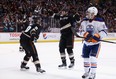 (L-R) Corey Perry #10 and Dustin Penner #17 of the Anaheim Ducks celebrate Penner's third period goal, as Sam Gagner #89 of the Edmonton Oilers looks on at Honda Center on December 15, 2013 in Anaheim, California. The Ducks defeated the Oilers 3-2.