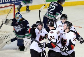 Calgary Hitmen players celebrate one of their 10 goals Sunday, Jan. 5, 2014, at the Saddledome in a 10-2 victory over the visiting Seattle Thunderbirds.