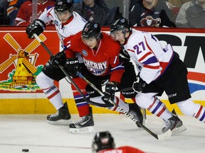 Team Orr's Leon Draisaitl, left, from Germany, and teammate Ben Thomas, right, squeeze Team Cherry's Michael Dal Colle, during first period CHL Top Prospects hockey action in Calgary, Alta., Wednesday, Jan. 15, 2014.