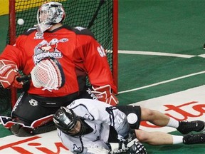 Mark Matthews of the Edmonton Rush scores on Calgary Roughnecks Frankie Scigliano at Rexall Place in Edmonton on Friday, Jan. 17, 2014.
Photograph by: Greg Southam, Edmonton Journal