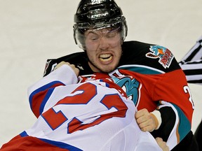Edmonton Oil Kings Edgars Kulda (foreground) and Kelowna Rockets Myles Bell fight during first period Western Hockey League game action in Edmonton on January 8, 2014.