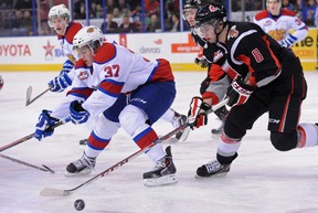 Dysin Mayo of the Edmonton Oil Kings, is unable to clear the puck from Scott Cooke of the Moose Jaw Warriors on Friday, Jan. 3, 2014, at Rexall Place in Edmonton.